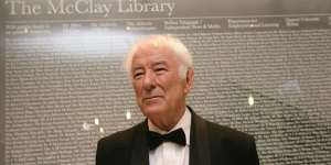Nobel prize-winning poet Seamus Heaney stands before a large glass panel listing all the benfactors before the offical opening of Queens Unversity's new McClay Library,Belfast.