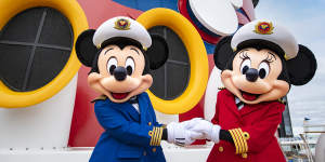 Captain Mickey Mouse and Captain Minnie Mouse greet guests on a Disney cruise.