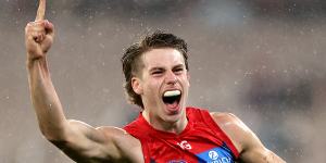 Caleb Windsor of the Demons celebrates kicking a goal.