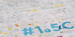 A giant postcard made of contributions from some 125,000 individual postcards containing messages to fight climate change stands on the Aletsch glacier in Switzerland.