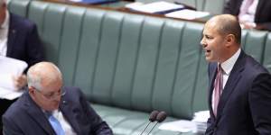 Prime Minister Scott Morrison on the phone during Question Time.