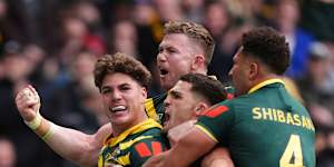 Reece Walsh celebrates with teammates after scoring a try,during the rugby league match between England and Australia.
