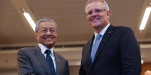 Malaysian Prime Minister Mahathir Mohamad (L) shakes hands with Australian Prime Minister Scott Morrison last month during a bilateral meeting on the sidelines of the Association of Southeast Asian Nations Summit in Singapore.