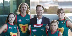 AFL chief Andrew Dillon with players to launch the Tasmanian Devils football club.