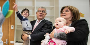 John Ajaka holds his grandson John Urbano,2,and Speaker Shelley Hancock holds 7 month old Audrey Richards,the daughter of MP Melanie Gibbons in the new parents room.