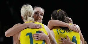 Australia players embrace each other after their loss to the United States in a women’s basketball quarterfinal game at the 2020 Summer Olympics,Wednesday,Aug. 4,2021,in Saitama,Japan.