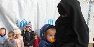 One of the Australian women in al-Hawl camp and a group of children.