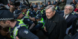 George Pell and barrister Robert Richter arrive at court under police guard in Melbourne in 2017.