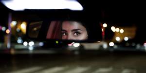 Hessah al-Ajaji drives her car down Riyadh busy Tahlia Street after midnight for the first time in June.