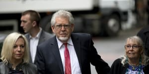 Rolf Harris arrives for his trial with wife Alwen Hughes,right,and daughter Bindi at Southwark Crown Court in London in 2014.