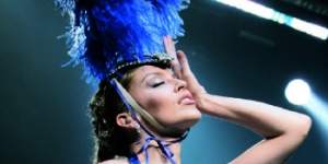 Minogue in the blue showgirl outfit from her Kylie Showgirl:The Greatest Hits tour.