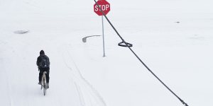 A person rides a bicycle through snow in McKinney,Texas.