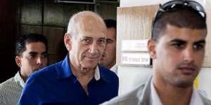 Ehud Olmert,left,leaves the Tel Aviv District Court on Tuesday after being sentenced to jail over his role in a bribery case.