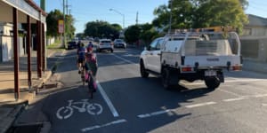 Cyclists have to go around cars parked in cycling lanes on Nudgee Road. Cyclists want this problem removed by making cycle paths separate from the road network.