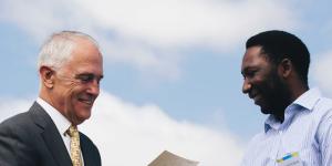 Prime Minister Malcolm Turnbull welcomes a new citizen at an Australia Day ceremony.