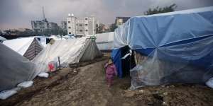 A displaced Palestinian child amid tents in the town of Khan Younis.