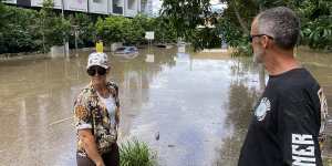 Rebecca and Jason Petzke look across to apartments where cars were flooded to their rooftops.