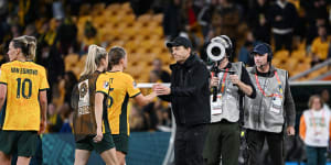 Australia coach Tony Gustavsson shakes hands with Clare Hunt after the match.