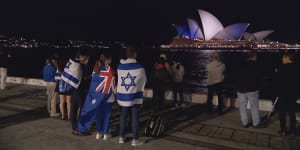 Warned off by police from attending the Sydney Opera House,supporters of Israel watched from afar on Monday night as it was lit up in blue and white. Pro-Palestinian protesters,meanwhile,filled the Opera House forecourt.