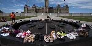 Shoes line the edge of the Centennial Flame on Parliament Hill in memory of the 215 children whose remains were found.