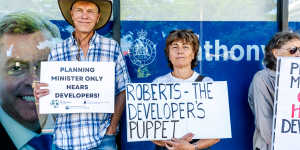 Protesters from the Total Environment Centre raise their concerns outside the Planning Minister’s electorate office.