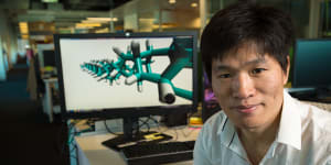 QUT's Dr Haifei Zhan with a molecular model of the diamond nanothread 