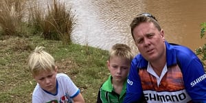 Matt Hansen (right),president of the Inland Waterways group,with his sons,Jack (left) and Cooper,near dead fish pulled from the Macquarie and Bell rivers near Dubbo in recent days.