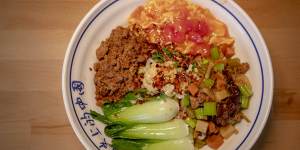 The dao xiao special biang noodle dish with pork mince,scrambled egg,potato,carrot and celery stir-fry and Asian greens.