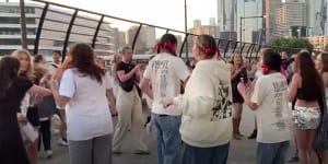 Taylor Swift fans dance outside the MCG