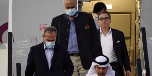 From left,Emad Sharghi,Morad Tahbaz and Siamak Namazi,former prisoners in Iran,walk out of a Qatar Airways flight in Qatar.