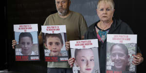 David and Varda Goldstein with photos of their grandchildren,Gal,Tal and Agam,and their mother,Chen,who were kidnapped on October 7.