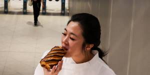 Frances Song,co-owner of Moon Phase bakery at St Leonards,with one of her chocolate bar croissants at nearby Crows Nest Metro station.