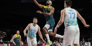 Australia's Patty Mills (5) puts up a shot against Slovenia's Luka Doncic (77) and Mike Tobey (10) during the men's bronze medal basketball game at the 2020 Summer Olympics,Saturday,Aug. 7,2021,in Tokyo,Japan. (AP Photo/Eric Gay)