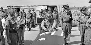 A South Vietnamese general pins a gallantry medal on Kevin Wheatley’s coffin.