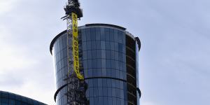 The banner on the crane next to Woodside’s Perth headquarters on Tuesday morning.