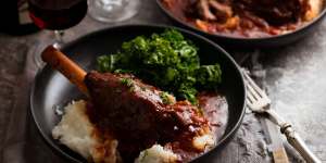 Lamb shanks cooked in red wine sauce and served with mashed potato and kale.