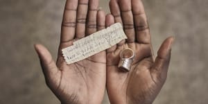 A Mauritanian migrant who crossed the US southern border shows the address of a Manhattan shelter he kept in the compartment of a ring during his journey.