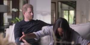 In a scene from their Netflix docuseries,Harry watches on while Meghan reenacts a curtsy.
