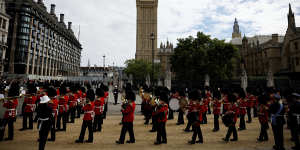 A marching band walks past Big Ben following Queen Elizabeth’s funeral.