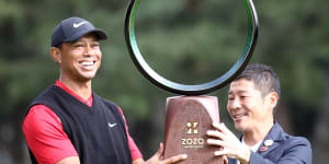 Golfer Tiger Woods receives the trophy from the Zozo founder Yusaku Maezawa at the Zozo Championship in Inzai,Chiba,Japan,last year.
