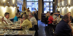 The dining room is a bona fide looker,all brooding leather,original terrazzo sandstone and cedar.