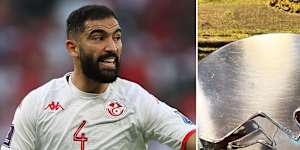 Yassine Meriah of Tunisia during the FIFA World Cup Qatar 2022 Group D match between Denmark and Tunisia in the Kappa jersey and The Mudflap Girl silhouette on a vintage belt buckle.