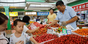 Customers at a produce market in Beijing.