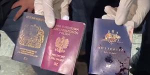 The bloodstained passports of three foreign nationals shown in a video shared on social media.