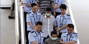The long reach of Operation Fox Hunt ... these men are among six accused fugitives taken back to China under escort from Indonesia in June 2015.