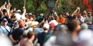 Min Woo Lee tees off on the 18th at The Australian in front of a huge gallery.