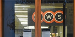 Workers in protective gear prepare to deep clean a Woolworths at Epping Plaza on Tuesday after it was listed as a tier 1 COVID-19 exposure site.