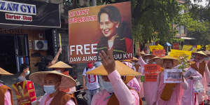 Buddhist nuns display images of deposed Myanmar leader Aung San Suu Kyi during a street march in Mandalay. 