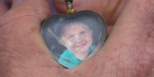 Ruth Pendergast holding the locket containing a lock of her grandson Baylen’s hair.