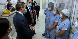 NSW Premier Chris Minns and new Health Minister Ryan Park meet medical staff at Liverpool Hospital on Thursday.